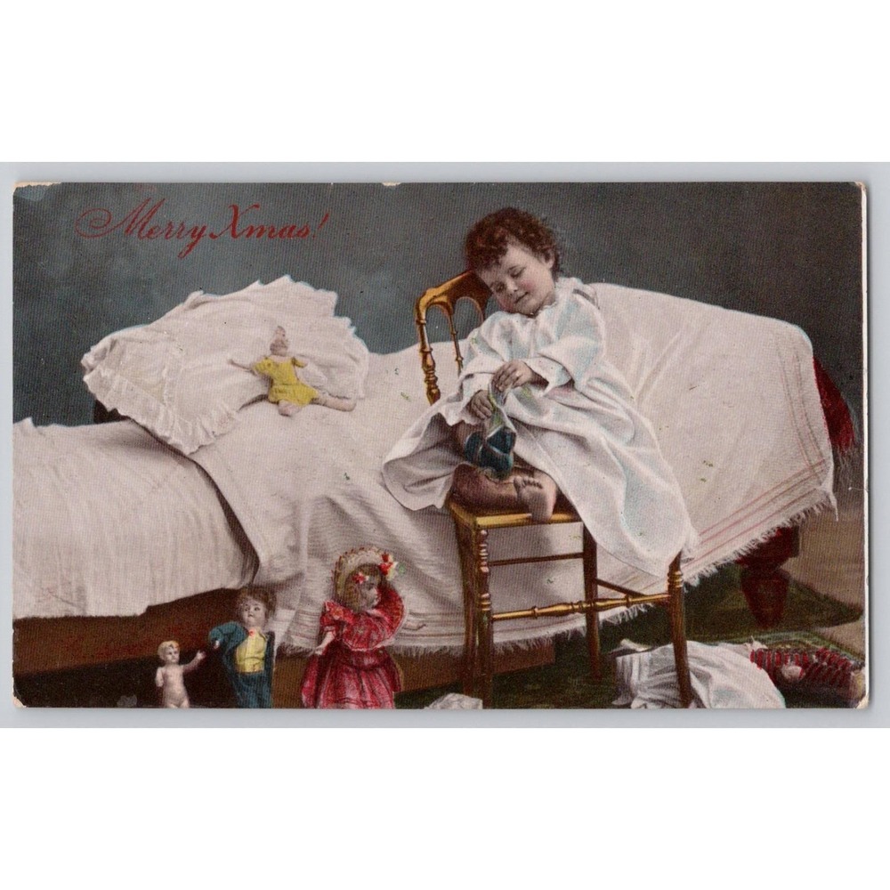 1913 Hand-Tinted Merry Christmas Postcard– Smiling Child with Socks & Dolls